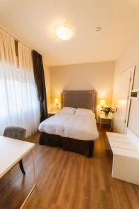 Postel nebo postele na pokoji v ubytování Hotel Viscardo