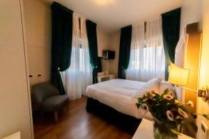 Postel nebo postele na pokoji v ubytování Hotel Viscardo