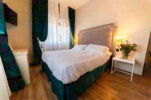 Postel nebo postele na pokoji v ubytování Hotel Viscardo
