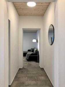 a hallway with a room with a bed and a mirror at Erdgeschoss-Appartement mit Seeblick in Ahrensbök