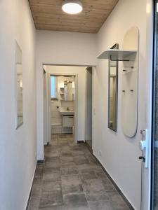 a hallway of a bathroom with a sink and a mirror at Erdgeschoss-Appartement mit Seeblick in Ahrensbök