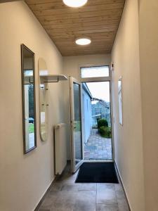 an empty hallway with an open door to a house at Erdgeschoss-Appartement mit Seeblick in Ahrensbök