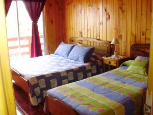 Łóżko lub łóżka w pokoju w obiekcie Hostal Libertad