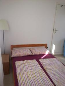 Postel nebo postele na pokoji v ubytování Apartments SID