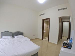Een bed of bedden in een kamer bij Karama Star Residence (Home Stay)