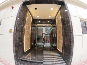 a hallway in a building with a marble wall at Karama Star Residence (Home Stay) in Dubai