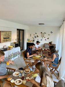 帕勞的住宿－B&B Le Farfalle，一群坐在餐桌上吃食物的人