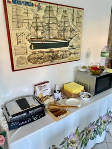 a table with a toaster and a printer and a picture of a ship at B&B Le Farfalle in Palau