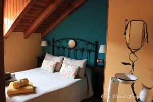 a bedroom with a bed with a mirror on the wall at Casa Begoña in Igüeña