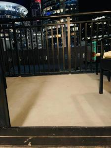 a balcony with a fence and a table and chairs at **Dream Luxury ** in the high rise downtown Orlando in Orlando