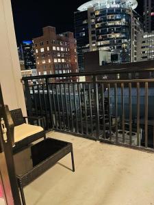 a chair on a balcony with a view of a city at **Dream Luxury ** in the high rise downtown Orlando in Orlando