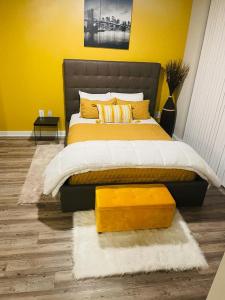 a bedroom with a large bed with a yellow wall at **Dream Luxury ** in the high rise downtown Orlando in Orlando