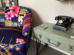 a room with a bed and a table with a telephone at Kelston Guest House in Weymouth