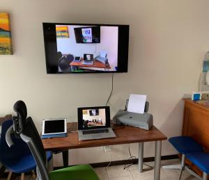 a desk with two laptops and a printer on it at Kitchenette near the Beach/including Breakfast in Búzios