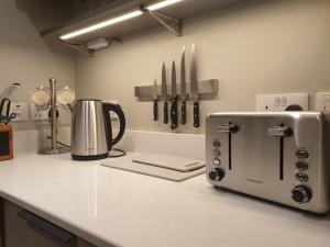 a kitchen counter with a toaster on a counter top at No8 3 bed cottage Winter Deals offered 3 nights or more Nov-Mar in Backbarrow