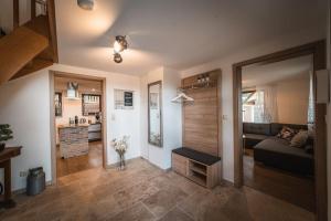 a living room with a couch and a kitchen at Sommerhaus am Nationalpark Eifel mit Sauna in Monschau +26 photos