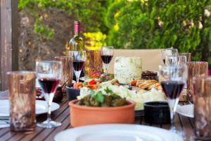 un tavolo con bicchieri da vino e un piatto di cibo di Ulivo Sea View House a Kokkíni Khánion
