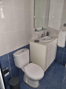 a bathroom with a white toilet and a sink at Cosy one bedroom apartment in Pafos in Paphos City