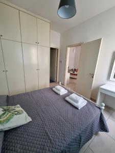 a bedroom with a bed with two towels on it at Cosy one bedroom apartment in Pafos in Paphos City