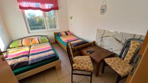 a room with a couch and a table and a chair at Pokoje goscinne DW Antom in Dźwirzyno