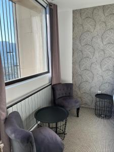 um quarto com duas cadeiras, uma mesa e uma janela em Prince apartment downtown em Budapeste