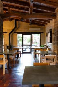 a dining room with wooden tables and wooden chairs at Gardenia in San Javier