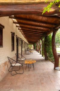 a patio with a table and chairs under a wooden roof at Gardenia Select in San Javier