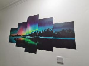 a group of four pictures hanging on a wall at Property Malak Homz - West Street 2 Bed Premium Apartment in Leicester