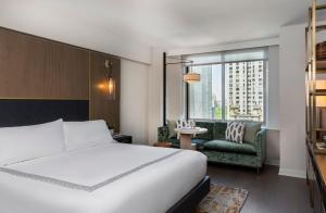 a hotel room with a bed and a window at Thompson Central Park New York, by Hyatt in New York