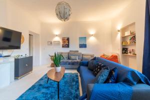 a living room with a blue couch and a table at BIG Flat - 2 FREE Parking - Virtual Visit ! in Nice