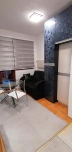 a living room with a couch and a table at Apartman De lux Zlatibor in Zlatibor