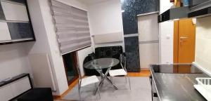 a dining room with a glass table and chairs at Apartman De lux Zlatibor in Zlatibor
