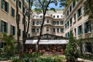 an exterior view of a large building with a patio at Rosewood São Paulo in São Paulo