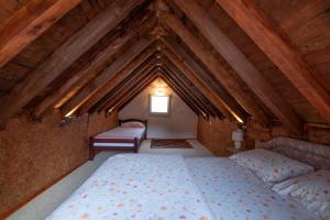 a bedroom with two beds in a attic at Cozy cottage, little paradise in the hinterland in Kotor