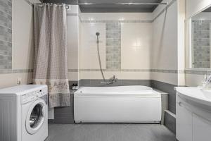 a bathroom with a washing machine and a washer at Apart Sdaem116 Studio in Kazan