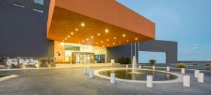 a building with a fountain in front of it at Real Inn Ciudad Juarez by the USA Consulate in Ciudad Juárez