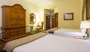 Llit o llits en una habitació de Quinta Real Aguascalientes