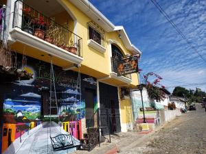 a yellow building with a store on a street at Hostal Las Veraneras Ataco in Concepción de Ataco
