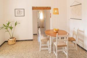 a dining room with a wooden table and chairs at Casa rural Can Pep de Sa Barda - Entre viñedos - Formentera Natural in Sant Francesc Xavier