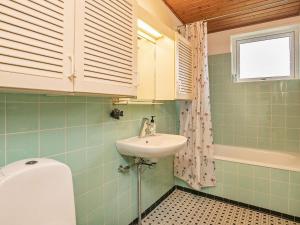 a bathroom with a sink and a toilet at 6 person holiday home in r sk bing in Ærøskøbing
