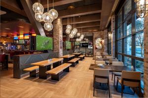 a restaurant with tables and chairs and a bar at SAHARA Las Vegas in Las Vegas
