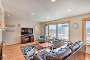 a living room with a couch and a table at Buena Vista Oasis with Mtn Views, 3 Mi to Dtwn! in Buena Vista
