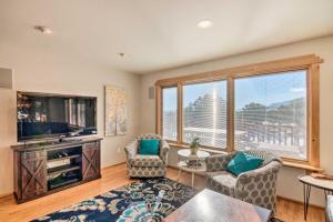 a living room with a tv and two chairs and a table at Buena Vista Oasis with Mtn Views, 3 Mi to Dtwn! in Buena Vista