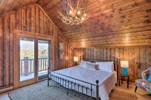 a bedroom with a bed in a room with wooden walls at Buena Vista Oasis with Mtn Views, 3 Mi to Dtwn! in Buena Vista