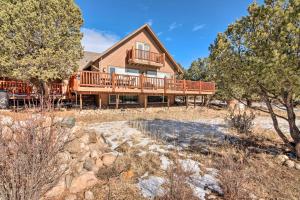 a home with a large deck and trees at Buena Vista Oasis with Mtn Views, 3 Mi to Dtwn! in Buena Vista