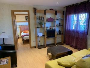 a living room with a couch and a room with a bed at El Rinconcillo - centro histórico de Toledo in Toledo