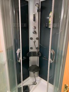 La salle de bains est pourvue d'une douche avec un tabouret. dans l'établissement El Rinconcillo - centro histórico de Toledo, à Tolède