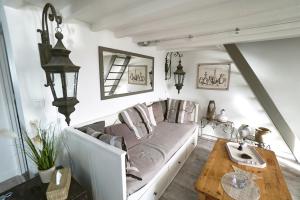 a living room with a couch and a table at La Perle du Chenal in Dieppe