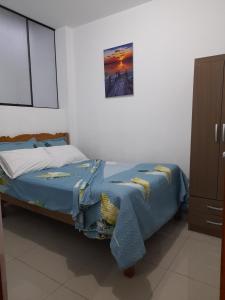 a bedroom with a bed and a picture on the wall at Cozy Whole Apartment in Lima