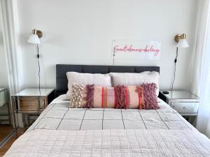 a bedroom with a bed with two night stands and two lamps at Lovely one-bedroom apartment with swiming pool, hot-tube and gym in central location in Vancouver